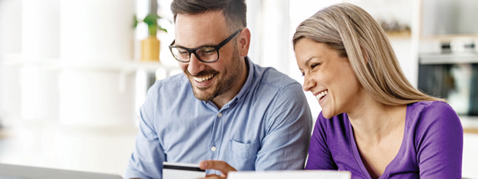 Smiling couple looking at a laptop