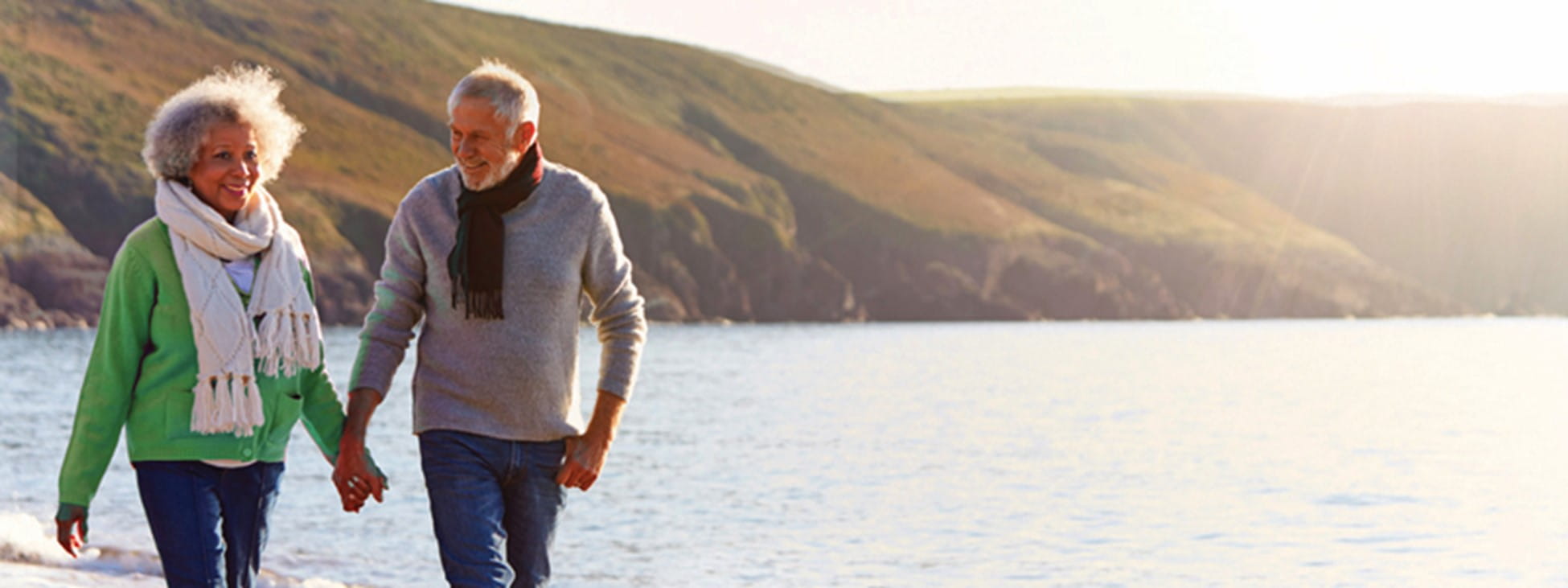 Man and woman walking along the coastline