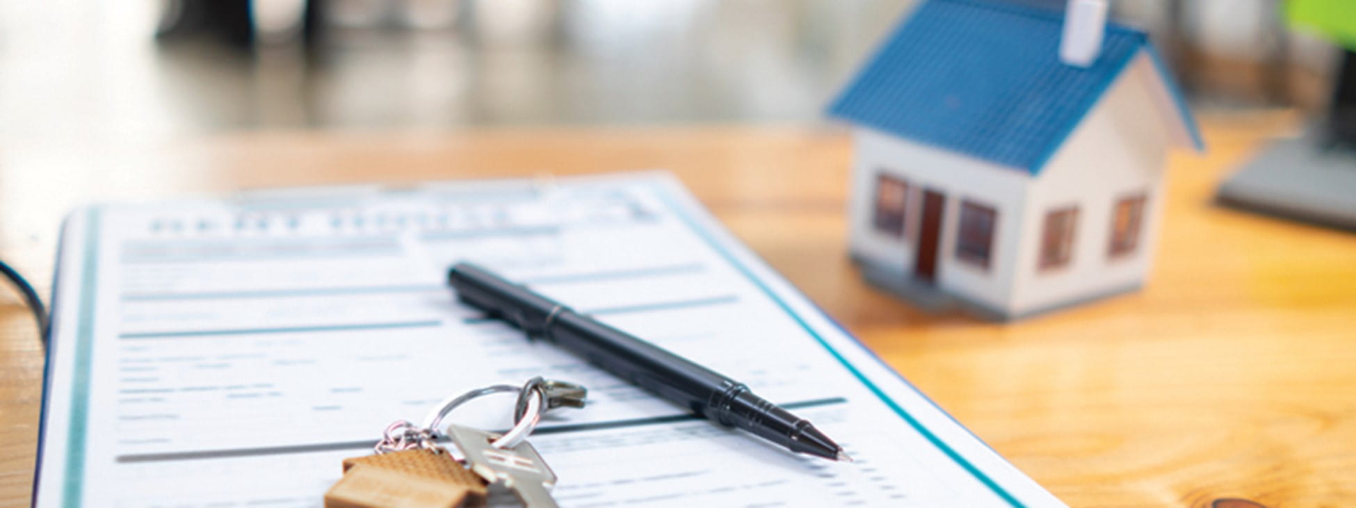 Paperwork, a pen, keys and a tiny house.