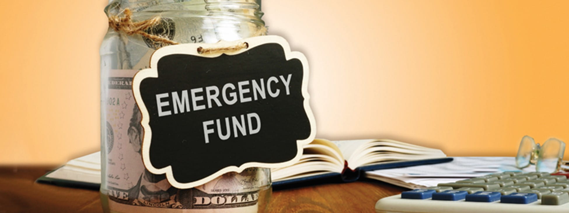 Money in a jar with the label 'emergency fund'
