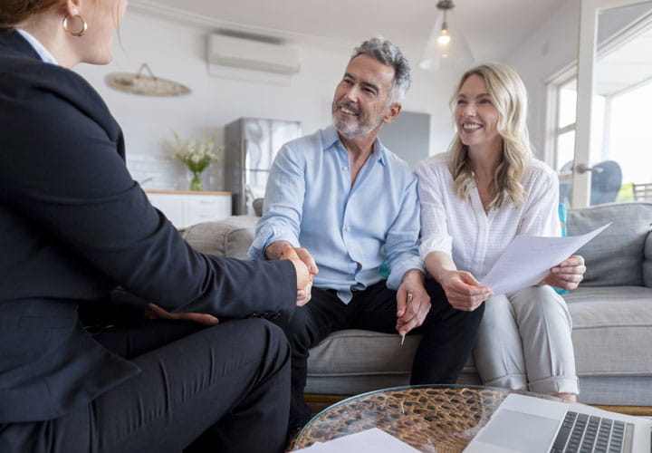 Couple on couch going over financial documents